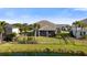 Beautiful fenced backyard overlooking the water, complemented by palm trees and lush landscaping at 3248 Anchor Bay Trl, Bradenton, FL 34211