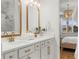 Bright bathroom featuring double vanity with gold fixtures and marble backsplash, with a bedroom view at 3248 Anchor Bay Trl, Bradenton, FL 34211