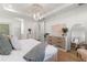 Beautiful bedroom featuring a modern chandelier, wood floors, and ample natural light at 3248 Anchor Bay Trl, Bradenton, FL 34211