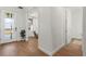 Hallway featuring wood-look tile flooring leading to the entry and office spaces at 3248 Anchor Bay Trl, Bradenton, FL 34211