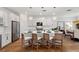 Stylish eat-in kitchen features white cabinets, stainless appliances, and modern pendant lighting at 3248 Anchor Bay Trl, Bradenton, FL 34211