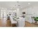 Stylish white kitchen with a large center island, pendant lighting, stainless steel appliances, and a wine cooler at 3248 Anchor Bay Trl, Bradenton, FL 34211