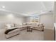 Spacious living room featuring a large sectional couch, tray ceiling, and abundant natural light at 3248 Anchor Bay Trl, Bradenton, FL 34211