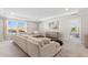 Spacious living room with tray ceilings, a large sectional sofa, and neutral decor at 3248 Anchor Bay Trl, Bradenton, FL 34211