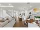 Bright open-concept living space featuring a modern kitchen, dining area, and comfortable seating by the staircase at 3248 Anchor Bay Trl, Bradenton, FL 34211