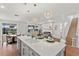 Open-concept living space showing the kitchen island, dining area, and living room with a fireplace, perfect for gatherings at 3248 Anchor Bay Trl, Bradenton, FL 34211