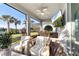 Relaxing screened patio with comfortable seating, an outdoor ceiling fan, and a view of the landscaped backyard at 3248 Anchor Bay Trl, Bradenton, FL 34211