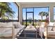 Relaxing screened patio with comfortable seating overlooking a tranquil lake and lush greenery at 3248 Anchor Bay Trl, Bradenton, FL 34211