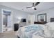 Bedroom featuring a ceiling fan, carpeted floors, attached bath and a dresser at 333 Arbor E Dr, Palm Harbor, FL 34683