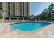 Large outdoor pool area with lounge chairs, umbrellas, and lush landscaping with resort views at 345 Bayshore Blvd # P9, Tampa, FL 33606