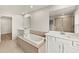 Luxurious bathroom featuring double vanities, soaking tub, and separate shower enclosure at 3460 Timber Crossing Ave, Brandon, FL 33511