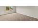 Cozy bedroom with a bright window, neutral carpet and walls, ideal for relaxation at 3460 Timber Crossing Ave, Brandon, FL 33511