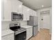 Kitchen featuring stainless steel appliances, range, and built-in microwave at 3460 Timber Crossing Ave, Brandon, FL 33511