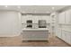 Bright modern kitchen with an island, stainless steel appliances, and white cabinetry at 3460 Timber Crossing Ave, Brandon, FL 33511