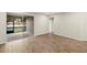 Bright living room featuring wood-look tile floor and sliding glass doors to patio with water view at 3460 Timber Crossing Ave, Brandon, FL 33511