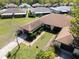 Aerial view of the home showcasing the well-manicured lawn, mature trees, and spacious driveway at 3479 Maclaren Dr, Palm Harbor, FL 34684