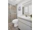 Functional bathroom with a shower, toilet, sink with mirror, and tile floor at 3479 Maclaren Dr, Palm Harbor, FL 34684