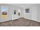 Bright bedroom featuring carpet, a white dresser, and ample natural light at 3479 Maclaren Dr, Palm Harbor, FL 34684
