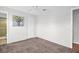 Simple bedroom with carpet, a ceiling fan and an entry to an ensuite bathroom at 3479 Maclaren Dr, Palm Harbor, FL 34684