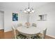 Dining room with table, chairs, chandelier, and view to exterior at 3479 Maclaren Dr, Palm Harbor, FL 34684