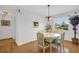 Dining room with table, chairs, chandelier, and view to exterior at 3479 Maclaren Dr, Palm Harbor, FL 34684