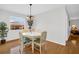 Dining room with table, chairs, chandelier, and view to exterior at 3479 Maclaren Dr, Palm Harbor, FL 34684