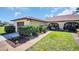 Charming single-story home with a well-manicured lawn and colorful, mature landscaping at 3479 Maclaren Dr, Palm Harbor, FL 34684