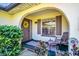 Inviting front porch with a decorative wreath, seating, and charming architectural details at 3479 Maclaren Dr, Palm Harbor, FL 34684