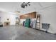 Functional garage featuring overhead storage, utility sink, and ample room for parking and storage at 3479 Maclaren Dr, Palm Harbor, FL 34684