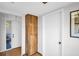 Hallway with a tall wood cabinet and white doors, leading to other rooms at 3479 Maclaren Dr, Palm Harbor, FL 34684
