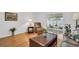 Comfortable living room with hardwood floors, leather furniture, and access to the patio at 3479 Maclaren Dr, Palm Harbor, FL 34684