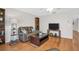 Comfortable living room with hardwood floors, ceiling fan and a contemporary entertainment center at 3479 Maclaren Dr, Palm Harbor, FL 34684