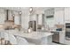 Modern kitchen with stainless steel appliances, a large island, and stylish pendant lighting at 3559 Santa Caterina Blvd, Bradenton, FL 34211