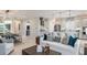 Open-concept living room and kitchen with white cabinets and stainless steel appliances at 3559 Santa Caterina Blvd, Bradenton, FL 34211