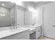 Bathroom vanity with double sinks, bright lighting, and framed mirror at 3563 Santa Caterina Blvd, Bradenton, FL 34211