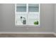 Bedroom features a window with blinds, light gray walls, and wood-look tile flooring at 3563 Santa Caterina Blvd, Bradenton, FL 34211