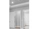 Hallway showcases neutral paint, white trim, and leads to doorways, creating a clean and modern feel at 3563 Santa Caterina Blvd, Bradenton, FL 34211