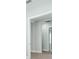 Hallway with doorway leading to other rooms with white trim and neutral walls at 3563 Santa Caterina Blvd, Bradenton, FL 34211