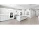 Bright kitchen featuring stainless steel appliances, a central island, and white cabinets at 3563 Santa Caterina Blvd, Bradenton, FL 34211