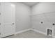 Clean, bright laundry room featuring tiled floors, utility connections, and plenty of storage space for convenience at 3563 Santa Caterina Blvd, Bradenton, FL 34211