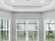 Bright living room with large windows offering plenty of natural light and tray ceiling at 3563 Santa Caterina Blvd, Bradenton, FL 34211