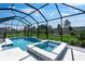 A refreshing screened-in pool and hot tub offer serene outdoor living with an expansive view and tiled deck at 3563 Santa Caterina Blvd, Bradenton, FL 34211
