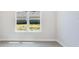 Bright, unfinished bedroom with luxury vinyl flooring and a large window at 3575 Santa Caterina Blvd, Bradenton, FL 34211
