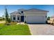 Beautiful single-Gathering home with a well-manicured lawn and paved driveway leading to an attached two-car garage at 3575 Santa Caterina Blvd, Bradenton, FL 34211
