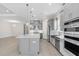Large kitchen with gray cabinets, an island, and stainless steel appliances at 3575 Santa Caterina Blvd, Bradenton, FL 34211