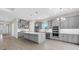 Spacious kitchen featuring gray cabinetry, a large center island, and stainless steel appliances at 3575 Santa Caterina Blvd, Bradenton, FL 34211