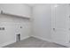 Clean laundry room with ample storage space above at 3575 Santa Caterina Blvd, Bradenton, FL 34211