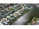An aerial view of waterfront homes with canals in a residential neighborhood featuring lush green lawns at 3805 Baden Dr, Holiday, FL 34691