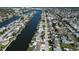 An aerial view of a canal-front neighborhood with homes lining the waterway, showcasing waterfront living at 3805 Baden Dr, Holiday, FL 34691