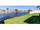Waterfront backyard with lush grass and picturesque views of the canal at 3805 Baden Dr, Holiday, FL 34691